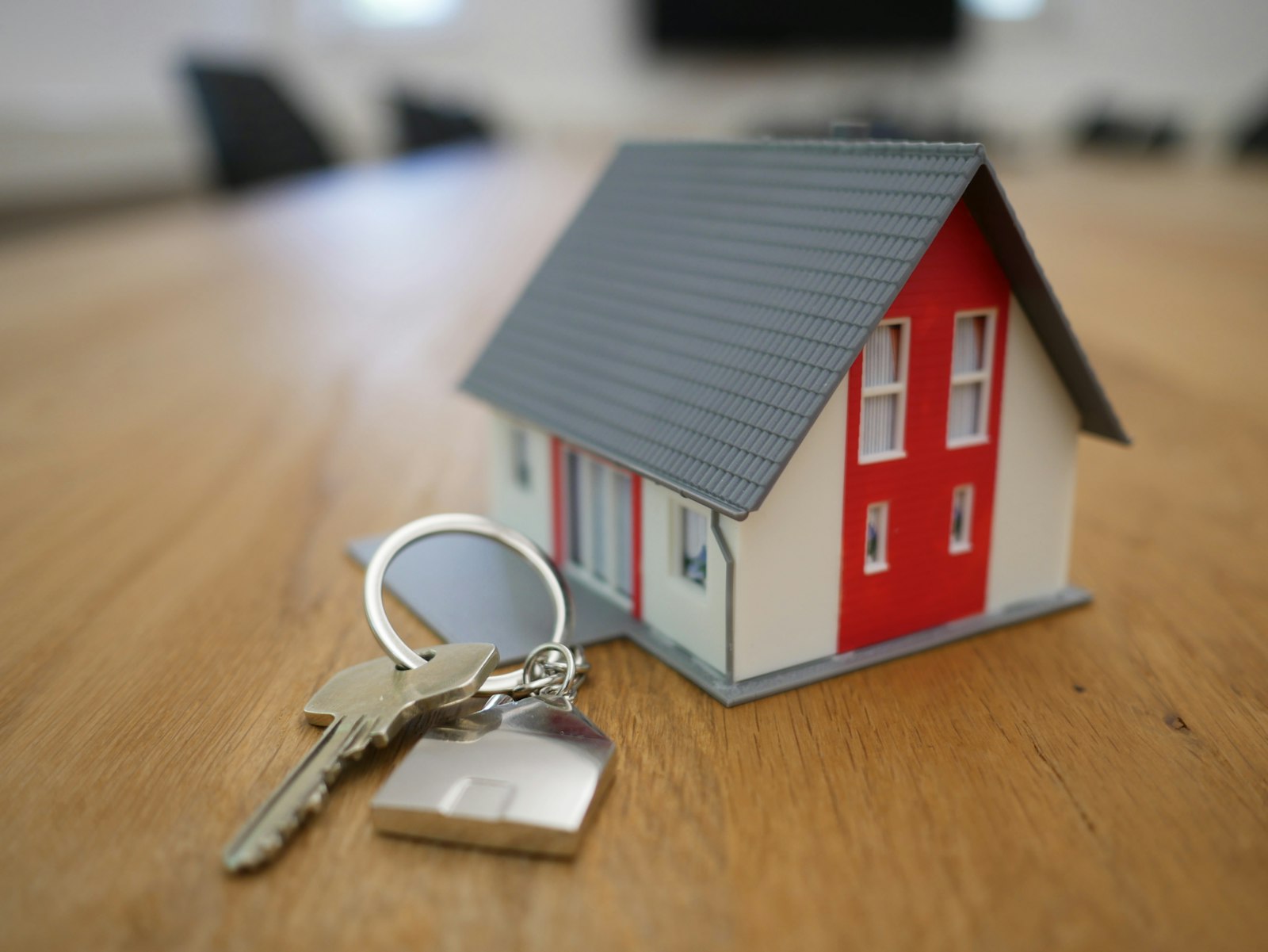 Model house with a key beside it