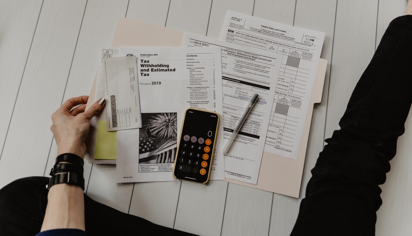 Bookkeeping records and a laptop on a St. Louis small business desk